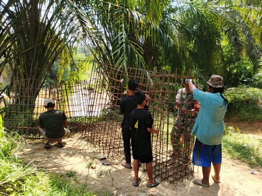 Babinsa 09/Kemuning Bersama Warga Gas Perakitan Besi Pondasi Jembatan Gantung
