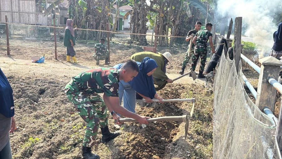 Personel Kompi Senapan B bersama warga masyarakat sekitar menggelar aksi gotong royong